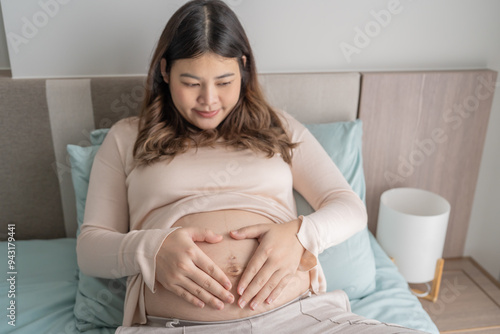 Pregnant asian woman holds hands on belly touching her baby caring about her health Beautiful happy pregnant woman tender mood photo of pregnancy Free Download Pregnant asian woman holds hands on belly touching her baby caring about her health Beautiful happy pregnant woman tender mood photo of pregnancy - GFXLoad
