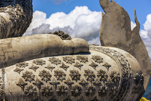 Canvas Print Background of a religious tourist attraction in Phitsanulok, Thailand, Wat Pa Rang Mi Wanaram, with a large Buddha statue on a mountain, overlooking the surrounding green rice fields