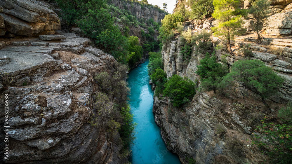 Koprulu Canyon. A close-up of the deep blue stormy mountain river that runs through the trees in Koprulu Canyon. Koprulu Canyon. A close-up of the deep blue stormy mountain river that runs through the trees in Koprulu Canyon.