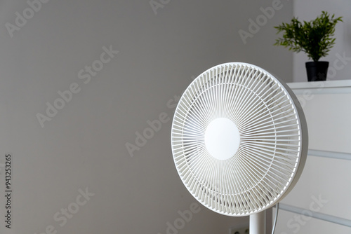 Woman using smart home app to control the fan. App. Floor fan. photo