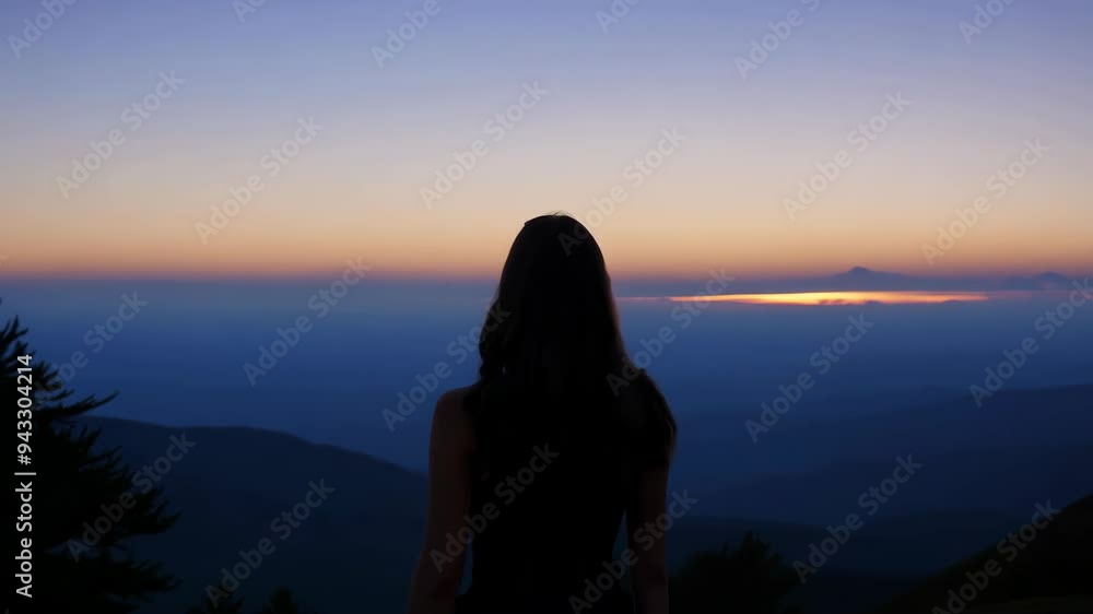 Woman on Hilltop at Sunset, Observing Majestic Mountain Panorama with Joy Woman on Hilltop at Sunset, Observing Majestic Mountain Panorama with Joy