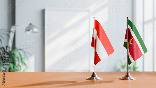 FLAGS OF AUSTRIA AND SURINAME ON TABLE