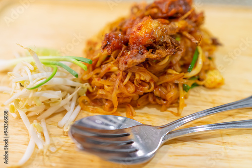 Thai food, Pad Thai, Noodle with soft shell crab with bean sprouts and spring onions on wooden plate
