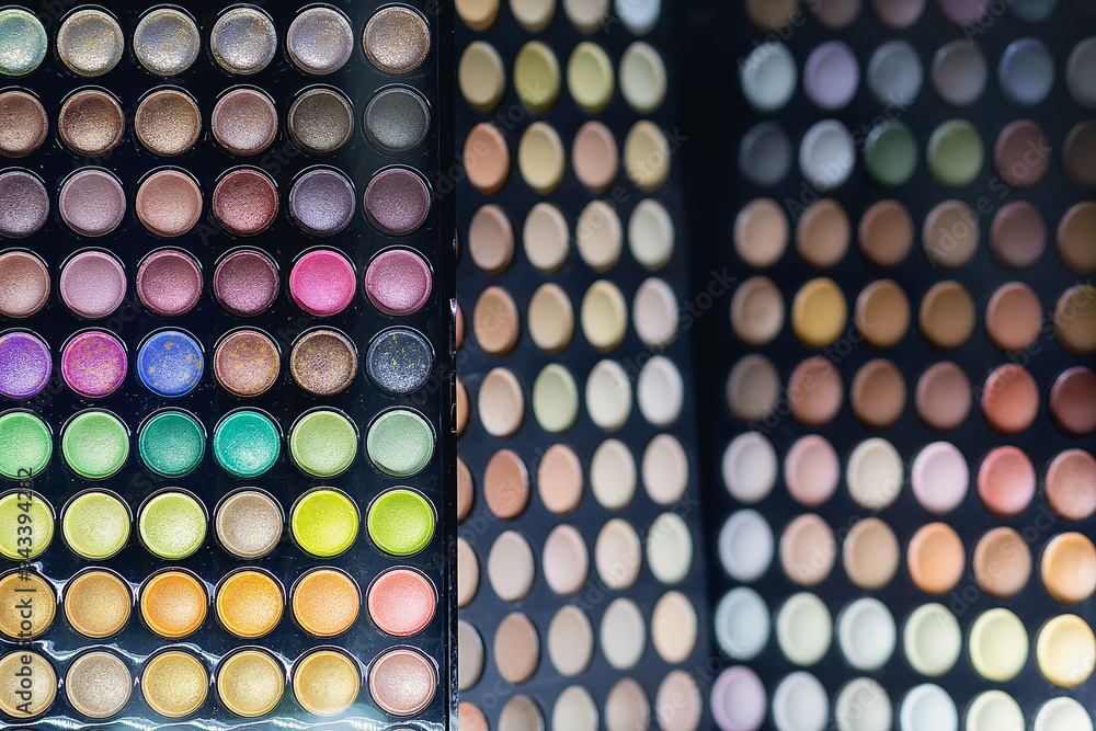 Variety of bright eyeshadow palettes on a store window Variety of bright eyeshadow palettes on a store window