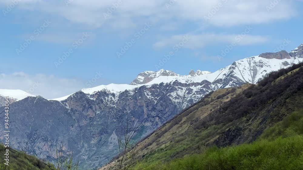 A trail in the green valley of the Karmadon gorge overlooking the Kolka glacier. The Main Caucasian Ridge. Summer view of the Karmadon gorge. A mountain valley after the collapse of rocks and ice. 4К A trail in the green valley of the Karmadon gorge overlooking the Kolka glacier. The Main Caucasian Ridge. Summer view of the Karmadon gorge. A mountain valley after the collapse of rocks and ice. 4К