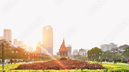 Phnom Penh ,Cambodia - 16th february, 2024: zoom out time lapse people tourist in motion walk in streets by The Independence Monument in Phnom Penh. Statue of King Father Norodom Sihanouk photo