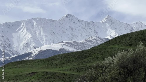 Wallpaper Mural A trail in the green valley of the Karmadon gorge overlooking the Kolka glacier. The Main Caucasian Ridge. Summer view of the Karmadon gorge. A mountain valley after the collapse of rocks and ice. 4К Torontodigital.ca