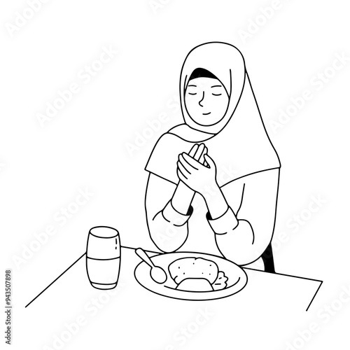 Muslim woman praying before eating at sahur