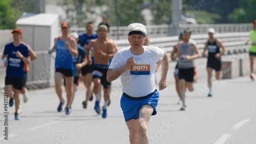 Male old runner jog sport marathon. Senior man athlete run. Elder jogger work out urban park. 60s sportsman train body. Health city life. Fast race slow motion. Active fit track. Motivation concept. photo