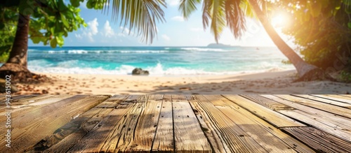Obraz na płótnie Wooden table featuring a sunny tropical beach background blurred to enhance focus ideal for showcasing summer products and presentations with copy space image w salonie