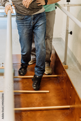 Therapist assisting patient with walking exercises during physical therapy session rehabilitation