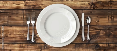 Obraz na płótnie Top view of an empty white porcelain plate with cutlery on a wooden table with copy space image w salonie