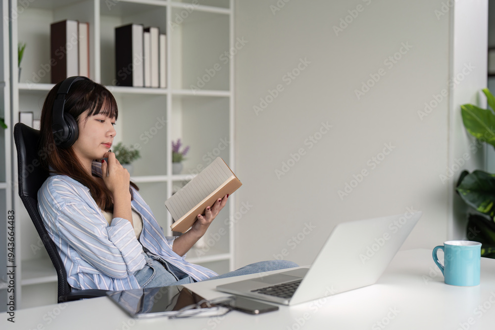 Focused Woman Combining Digital and Traditional Learning Focused Woman Combining Digital and Traditional Learning
