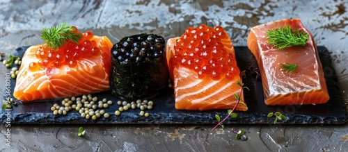 Sandwiches topped with black sturgeon and red chum salmon caviar on a slate serving board. with copy space image. Place for adding text or design photo