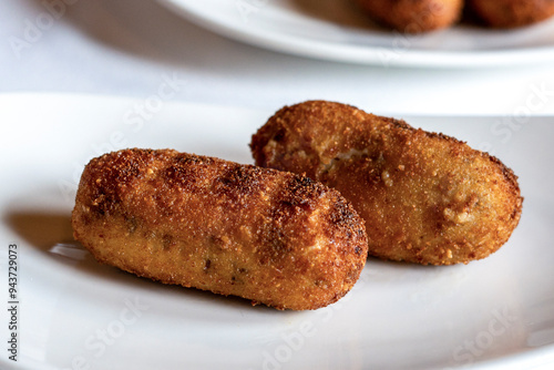 fried croquettes on a white plate