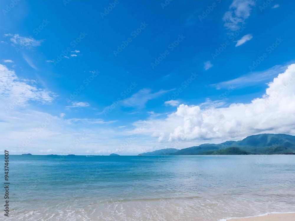 A sunlit cloudscape over sea and mountain A sunlit cloudscape over sea and mountain