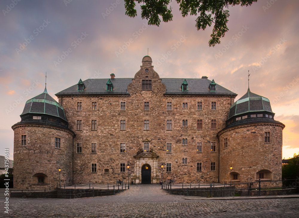 Medieval Orebro Castle is a fortification at Svartan river in sunset, light . Tourist atraction and history entusiast destination. Sweden Medieval Orebro Castle is a fortification at Svartan river in sunset, light . Tourist atraction and history entusiast destination. Sweden