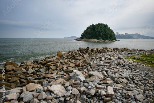 View from the rocks of the breakwater to the Urubuquecaba Island of Santos, coastal city of the interior of Sao Paulo, SP, Brazil. photo