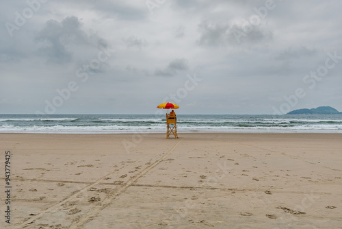Beach lifeguard in the middle of the beach on a cloudy day and no people on the sea. Tombo beach, Guaruja - SP, Brazil.
