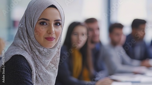 Beautiful muslim businesswoman presents a project to a young diverse team of people in a modern office 