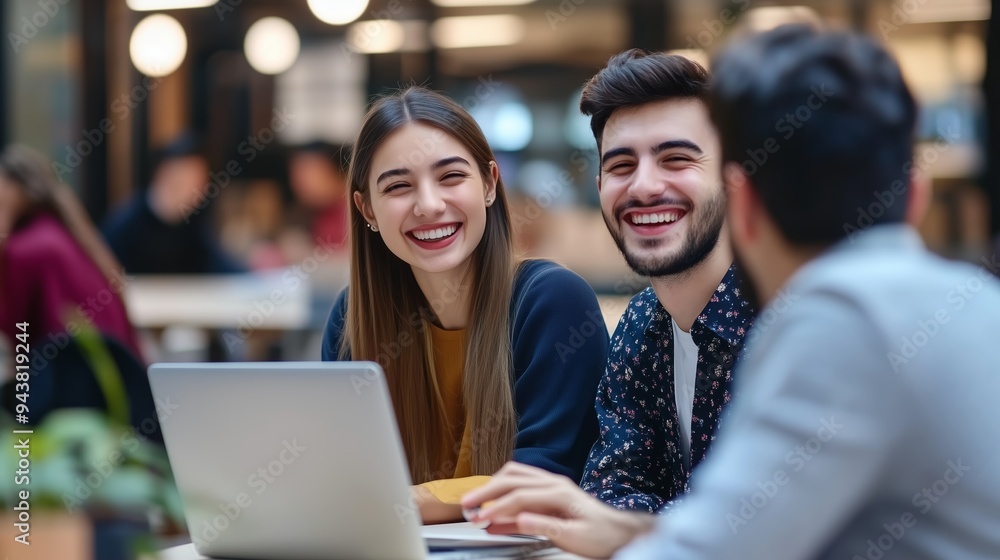 Three friends enjoying a cheerful moment while studying together in a modern café during the afternoon Three friends enjoying a cheerful moment while studying together in a modern café during the afternoon