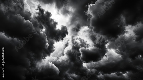 Dramatic dark clouds forming a stormy sky, captured in monochrome. Perfect for representing tumultuous weather and intense atmospheres.