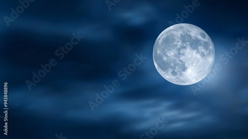 The full moon emits a soft glow through the night sky, lightly veiled by clouds, evoking a sense of peaceful solitude.