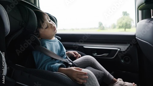 toddler girl sitting and sleeping in a car seat, safety baby chair travelling
