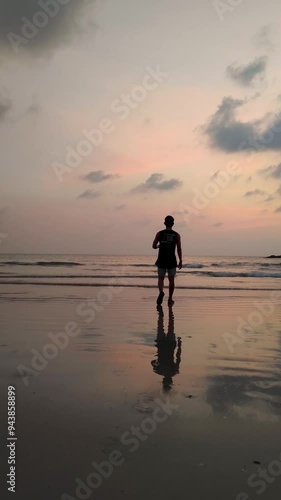 Silhouette A Man Walking on Twilight sky sunset and reflection on the sea water at Nang Thong Beach at Khao Lak Phang Nga Thailand - Seascape chill vibe on the beach - Footage