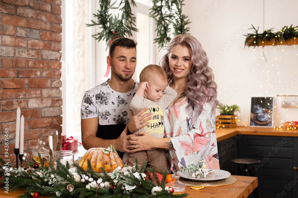 family enjoying their time together at home in the kitchen on Christmas time family enjoying their time together at home in the kitchen on Christmas time
