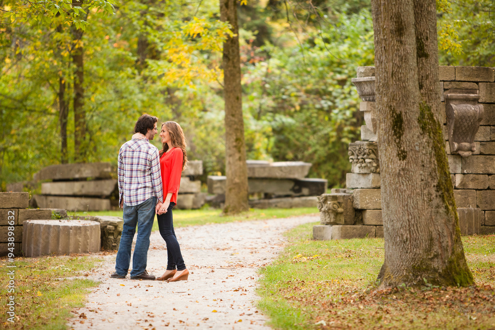 Young Couple Standing on Walkway in Park in Autumn, Ontario, Canada Young Couple Standing on Walkway in Park in Autumn, Ontario, Canada