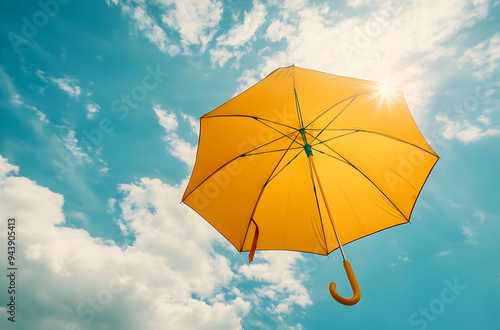 A vibrant yellow umbrella floating against a clear blue sky, radiating warmth and a sense of carefree summer bliss.