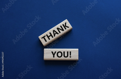 Thank you symbol. Wooden blocks with words Thank you. Beautiful deep blue background. Business and Thank you concept. Copy space.
