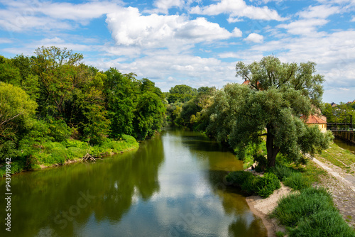 View from the old stone bridge of the Unterer Wöhrd or Lower Wöhrd island across from the historic old town on the Danube River at Regensburg, Germany.