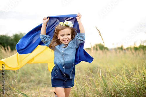 Ukraines Independence Flag Day. Constitution day. Ukrainian child girl in embroidered shirt vyshyvanka with yellow and blue flag of Ukraine in field. flag symbols of Ukraine. Kyiv, Kiev day photo