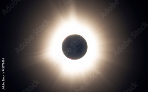 Totality of a solar eclipse with the suns corona seen. A few solar prominences also exist; Fredricton, New Brunswick, Canada photo