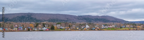 View across from Annapolis Royal on a moody spring day, Nova Scotia. Multi coloured homes dot the landscape; Annapolis Royal, Nova Scotia, Canada