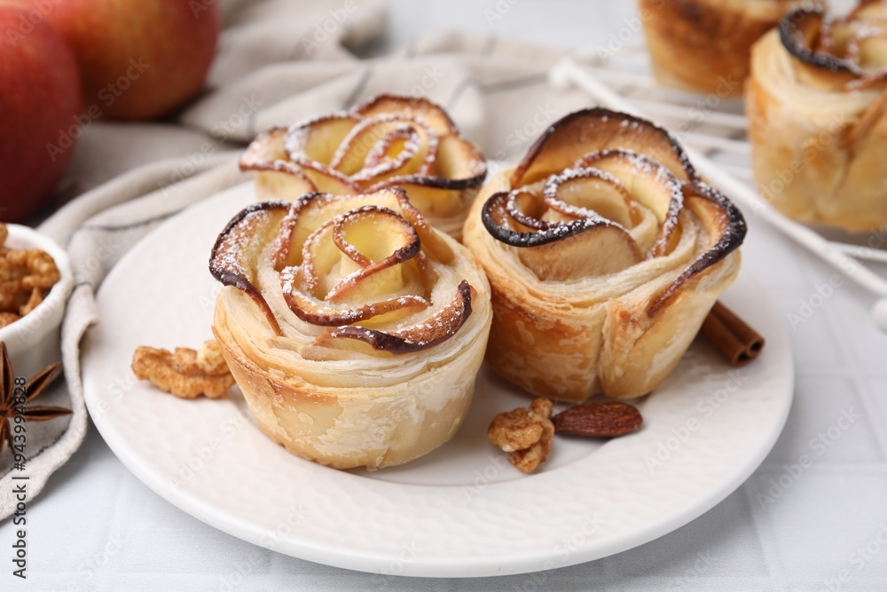 Freshly baked apple roses and walnuts on white tiled table, closeup. Puff pastry Freshly baked apple roses and walnuts on white tiled table, closeup. Puff pastry