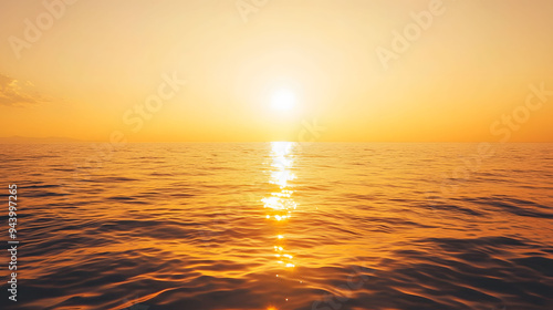 A serene sunset over ocean creates warm, tranquil atmosphere, reflecting golden hues on waters surface.