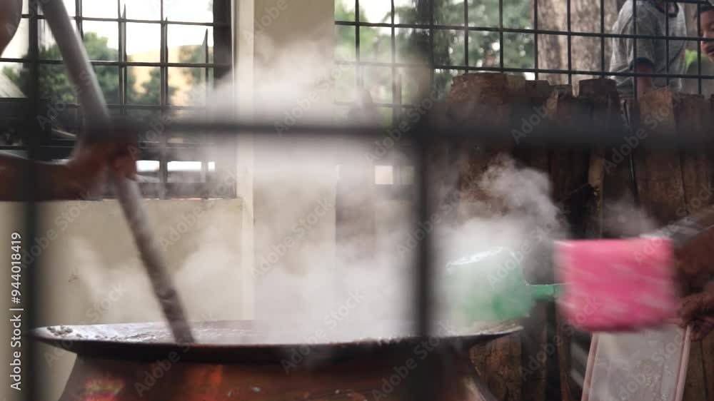 The process of cooking the spicy porridge in a large pan before it is distributed to the people around the Medan Grand Mosque. The Spicy porridge is a Malay Deli traditional cuisine. The process of cooking the spicy porridge in a large pan before it is distributed to the people around the Medan Grand Mosque. The Spicy porridge is a Malay Deli traditional cuisine.
