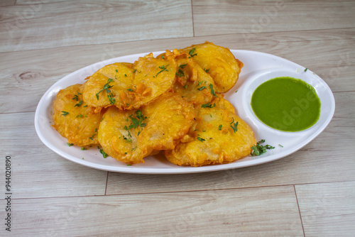 Isolated Basin Pakora, Popular indian street food snack called potato pakoda on wooden background