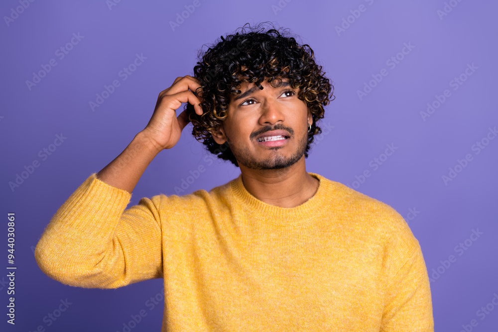 Photo of worried nervous man wear trendy yellow clothes hmm look empty space isolated on violet color background Photo of worried nervous man wear trendy yellow clothes hmm look empty space isolated on violet color background