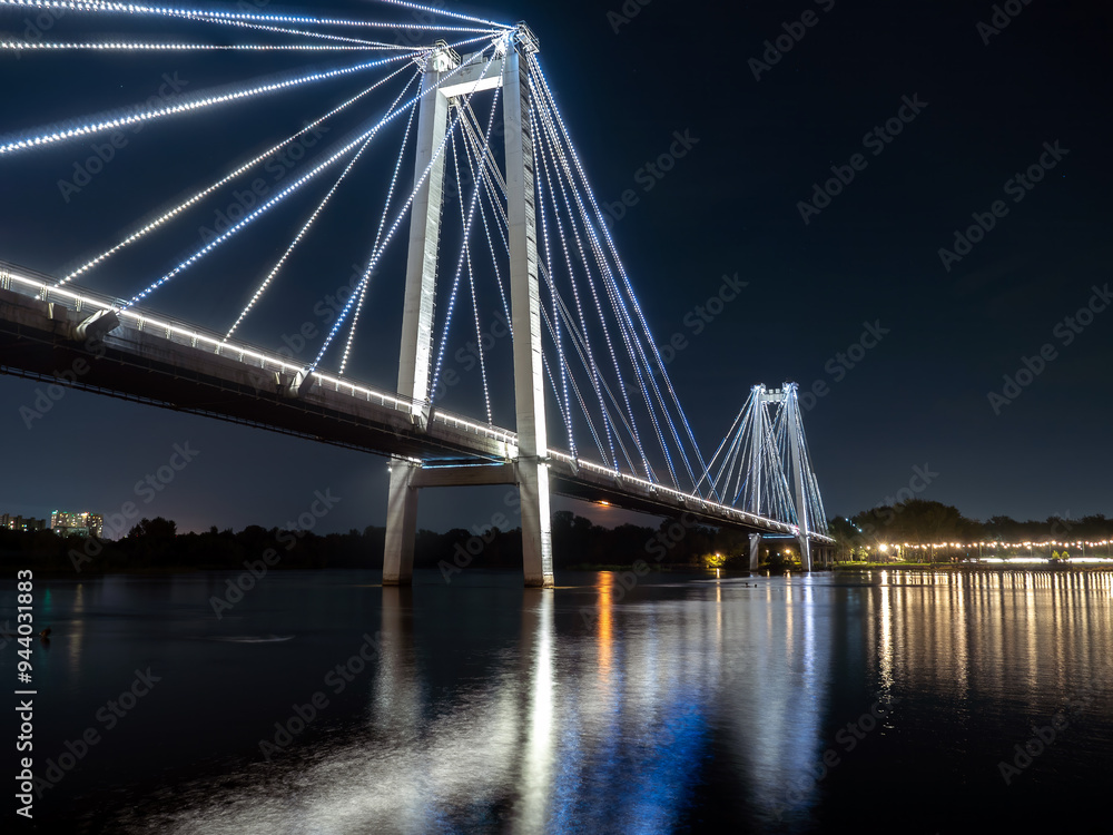 A bridge over a wide river with night illumination. A bridge over a wide river with night illumination.