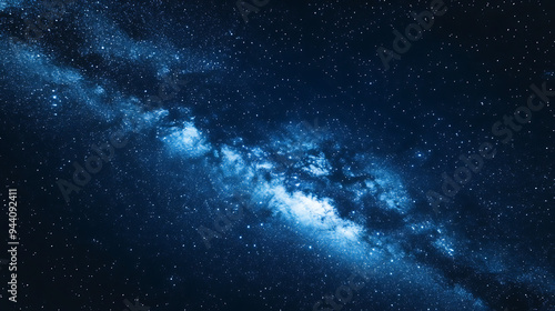 A stunning view of the Milky Way galaxy, with a dense band of stars and gas clouds stretching across a dark blue sky.