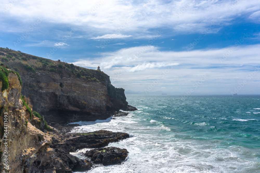 A stunning lighthouse perched on the dramatic cliffs of Otago's coast, New Zealand. Overlooking the Pacific Ocean, this spot offers breathtaking views, perfect for summer outings, birdwatching A stunning lighthouse perched on the dramatic cliffs of Otago's coast, New Zealand. Overlooking the Pacific Ocean, this spot offers breathtaking views, perfect for summer outings, birdwatching