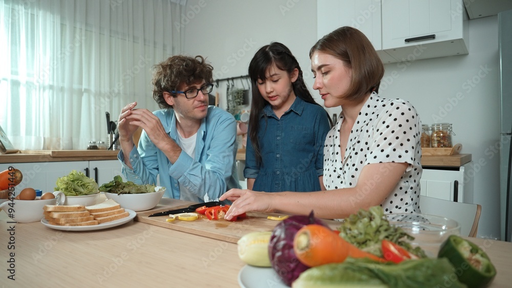 Happy father move to music while cooking food and prepare lunch at modern kitchen. Active dad dancing to song while making healthy food or salad surrounded with vegetable and kitchenware. Pedagogy. Happy father move to music while cooking food and prepare lunch at modern kitchen. Active dad dancing to song while making healthy food or salad surrounded with vegetable and kitchenware. Pedagogy.