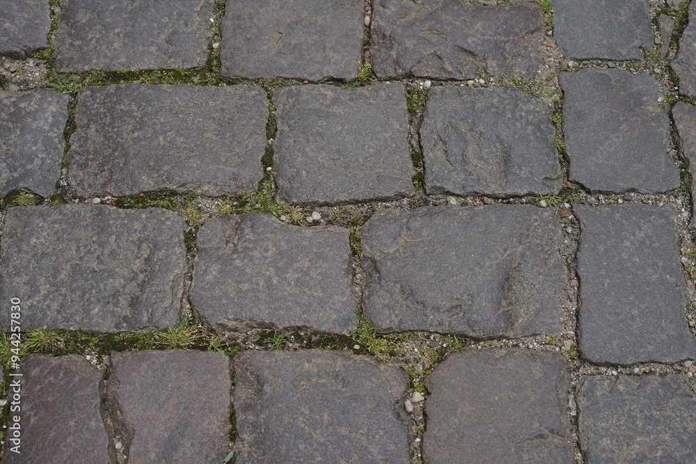 Cobblestone tiles street with big stones, top view. Ancient stone floor. Old pavement Cobblestone tiles street with big stones, top view. Ancient stone floor. Old pavement