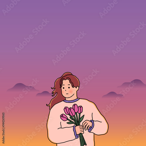 A woman standing with flowers against the background of the sunset
