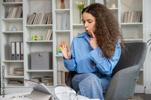 Young speech therapist having an online session with the patient