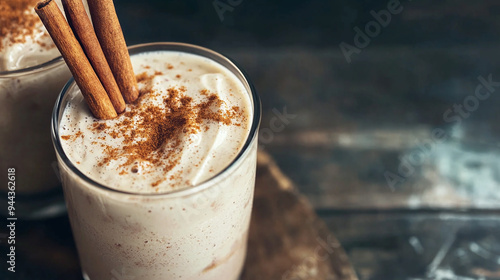 a creamy horchata smoothie topped with a cinnamon stick, served in a rustic glass